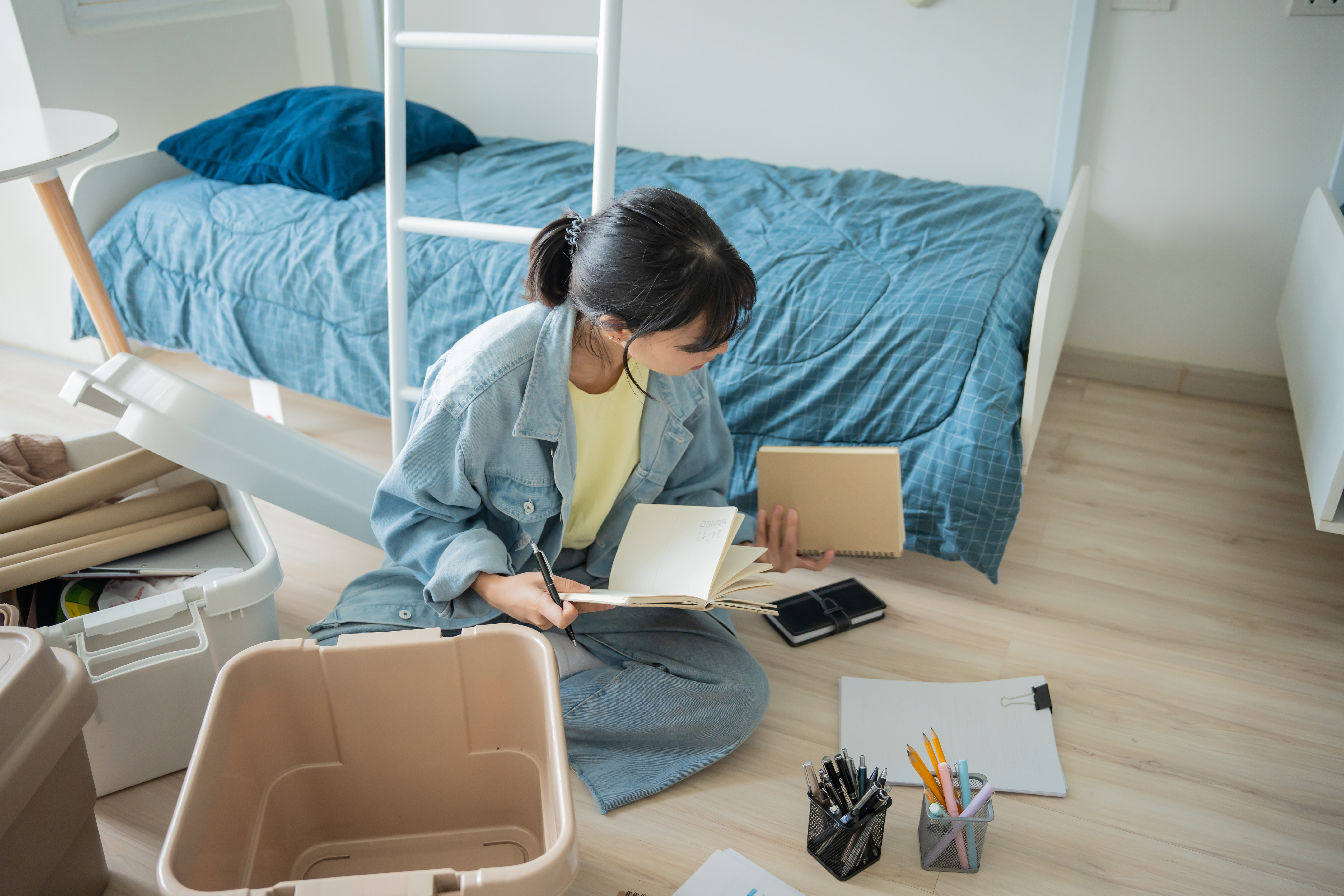 Galveston college student following a storage checklist while packing for semester move-out